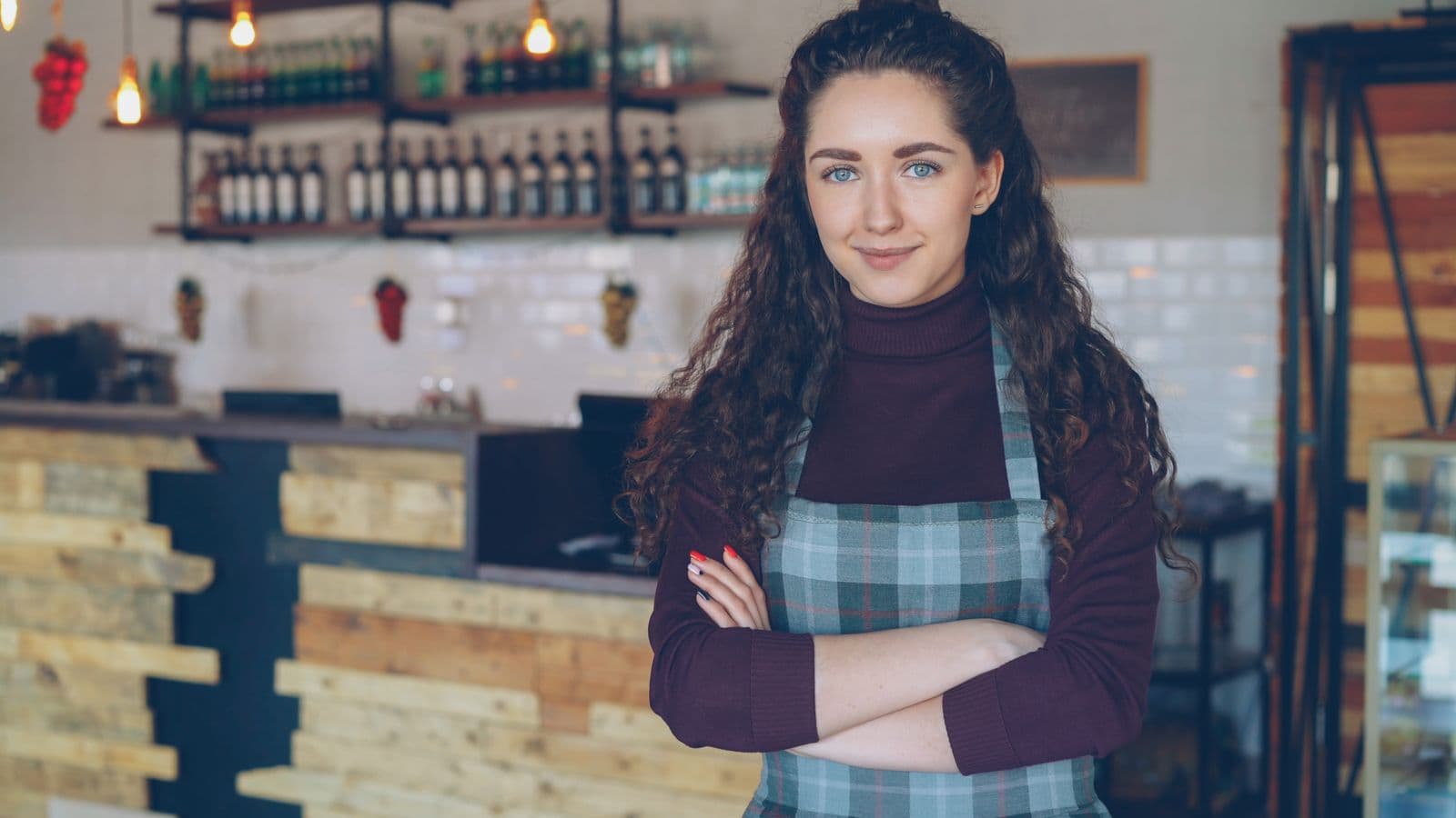 A small-business owner standing confidently in her shop