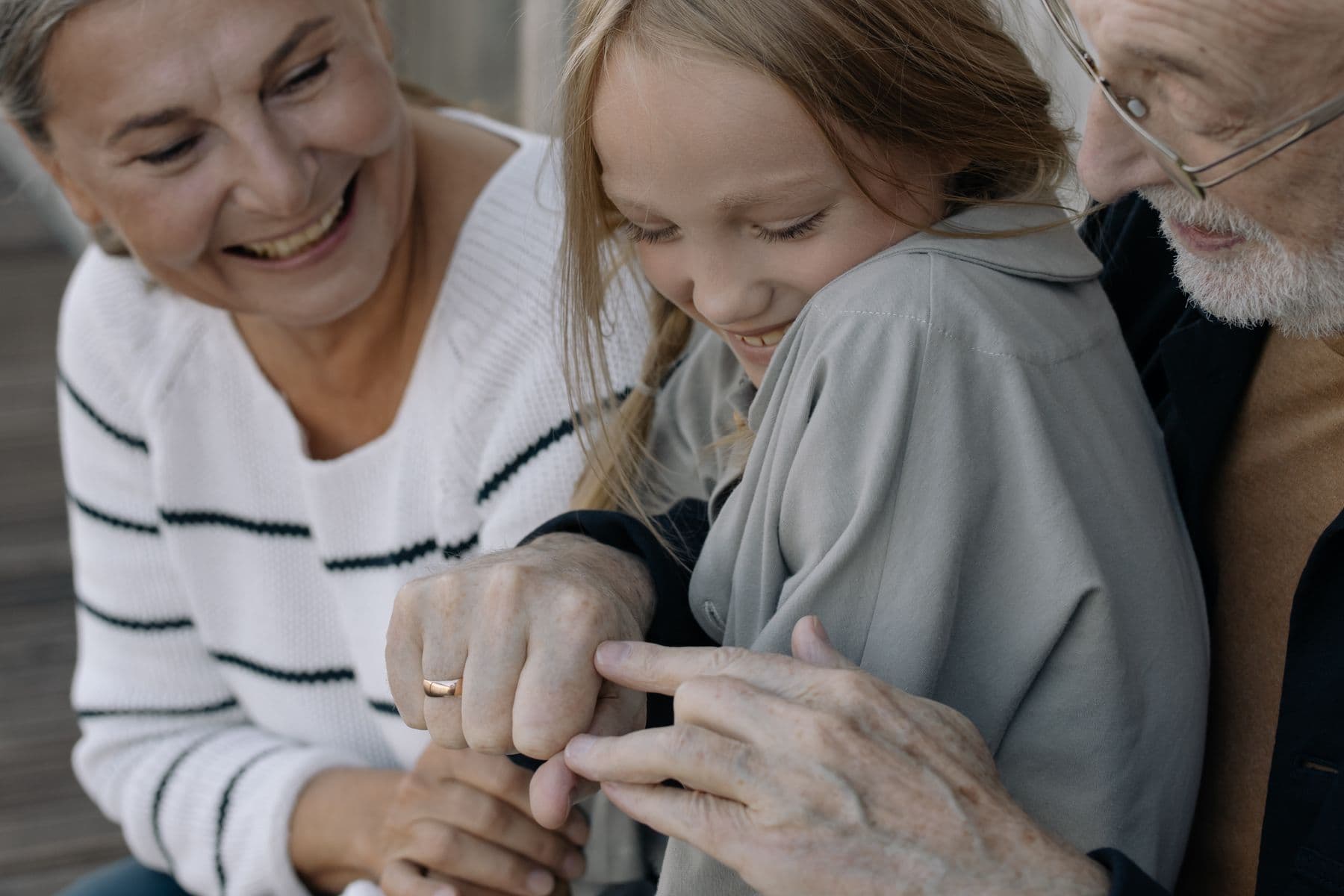 A grandmother, grandfather, and grandchild sharing a warm moment together